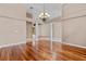 Spacious living room with hardwood floors, chandelier and architectural columns creating an open floor plan at 875 Bentley Green Cir, Winter Springs, FL 32708