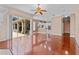 Large living room featuring wood floors, ceiling fan and seamless transition to the kitchen area at 875 Bentley Green Cir, Winter Springs, FL 32708