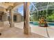 Covered patio with tiled floor and view of screened-in pool and spa at 875 Bentley Green Cir, Winter Springs, FL 32708