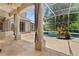 Covered patio with columns overlooking screened-in pool and spa at 875 Bentley Green Cir, Winter Springs, FL 32708
