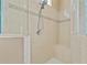 Tiled shower with seat, glass doors, and decorative tile border at 875 Bentley Green Cir, Winter Springs, FL 32708