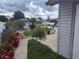 Landscaped backyard with blooming flowers, mature trees, a pool, and a shed at 8850 Pine Bay Ct, Orlando, FL 32825