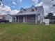 Charming two-story home with a brick facade, covered front porch, manicured lawn, and a detached garage at 8850 Pine Bay Ct, Orlando, FL 32825