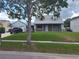 Charming home with a brick facade, covered front porch, manicured lawn, and a detached garage at 8850 Pine Bay Ct, Orlando, FL 32825