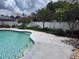 Inviting backyard swimming pool surrounded by a concrete deck and lush landscaping at 8850 Pine Bay Ct, Orlando, FL 32825