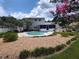 Lovely backyard featuring a refreshing in-ground pool, mature landscaping, and screened in porch at 8850 Pine Bay Ct, Orlando, FL 32825
