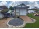 Backyard shed with adjacent landscaping and a small ramp for easy access at 8850 Pine Bay Ct, Orlando, FL 32825