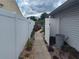 Side yard with white privacy fence, walkway, and landscaping providing a secluded outdoor space at 8850 Pine Bay Ct, Orlando, FL 32825