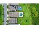 A high angle view shows a neighborhood with large lawns and houses with pools and solar panels at 9068 Sonoma Coast Dr, Winter Garden, FL 34787