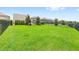 Expansive backyard with lush green grass, enclosed by a sleek black fence, offers plenty of room for recreation at 9068 Sonoma Coast Dr, Winter Garden, FL 34787