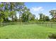 Expansive backyard with lush green grass, enclosed by a sleek black fence, offers plenty of room for recreation at 9068 Sonoma Coast Dr, Winter Garden, FL 34787