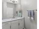 Bathroom featuring a granite countertop, white cabinetry and a framed mirror at 9068 Sonoma Coast Dr, Winter Garden, FL 34787