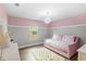 Cozy bedroom with a daybed, decorative rug, and charming chandelier at 9068 Sonoma Coast Dr, Winter Garden, FL 34787