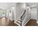 Inviting foyer with wood-look tile flooring and staircase with decorative iron spindles at 9068 Sonoma Coast Dr, Winter Garden, FL 34787