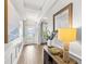 Bright foyer features wood floors, a decorative table lamp, and wainscotting at 9068 Sonoma Coast Dr, Winter Garden, FL 34787