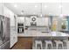 Open concept kitchen features a large island, granite counters, and stainless steel appliances at 9068 Sonoma Coast Dr, Winter Garden, FL 34787