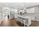 Bright kitchen features a large island with seating, white cabinets, and stainless steel appliances at 9068 Sonoma Coast Dr, Winter Garden, FL 34787
