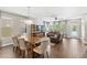 Open-concept living room featuring a wooden dining table and leather sofa at 9068 Sonoma Coast Dr, Winter Garden, FL 34787