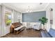 Cozy living room with neutral walls, wood floors, piano, and comfortable seating at 9068 Sonoma Coast Dr, Winter Garden, FL 34787