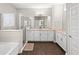 Well-lit main bathroom featuring double sinks, white cabinets, and glass shower at 9068 Sonoma Coast Dr, Winter Garden, FL 34787