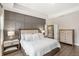 Comfortable main bedroom with a tray ceiling and dark wood accent wall at 9068 Sonoma Coast Dr, Winter Garden, FL 34787