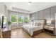 Spacious main bedroom featuring a tray ceiling and large windows overlooking the backyard at 9068 Sonoma Coast Dr, Winter Garden, FL 34787