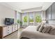 Main bedroom features a tray ceiling, large windows and neutral decor at 9068 Sonoma Coast Dr, Winter Garden, FL 34787