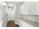 Mud room with white cabinetry, granite countertops and tile backsplash at 9068 Sonoma Coast Dr, Winter Garden, FL 34787
