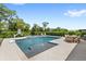 Inviting pool and spa featuring a basketball hoop, outdoor dining, and lounging areas, all surrounded by lush landscaping at 9068 Sonoma Coast Dr, Winter Garden, FL 34787