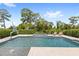 Relaxing backyard pool featuring two lounge chairs, a basketball hoop, and a stunning wooded view at 9068 Sonoma Coast Dr, Winter Garden, FL 34787