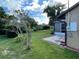Lush backyard featuring a screened porch and well-maintained landscaping at 1025 Sullivan St, Deltona, FL 32725