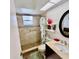 This bathroom features a walk-in shower, vanity sink, and decorative details at 1025 Sullivan St, Deltona, FL 32725