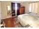 Cozy bedroom with hardwood floors, a mirror, and a comfortable bed at 1025 Sullivan St, Deltona, FL 32725