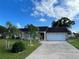 Charming single-story home with a well-manicured lawn and a two-car garage on a sunny day at 1025 Sullivan St, Deltona, FL 32725