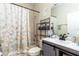 Well-lit bathroom featuring a vanity with gray cabinets and a shower-tub combo at 1021 Jaybee Ave, Davenport, FL 33897