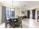 Bright dining room with large window, a modern table set and neutral walls at 1021 Jaybee Ave, Davenport, FL 33897