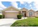 Charming single-story home featuring a well-maintained lawn and a two-car garage at 1021 Jaybee Ave, Davenport, FL 33897