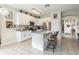 Well-lit kitchen with stainless steel appliances, white cabinets, and a granite countertop island at 1021 Jaybee Ave, Davenport, FL 33897
