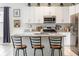Stylish kitchen featuring granite countertops, white cabinets, and stainless steel appliances at 1021 Jaybee Ave, Davenport, FL 33897