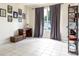 Neutral living room with tiled floors, large window, and decorative furnishings at 1021 Jaybee Ave, Davenport, FL 33897