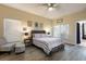Cozy main bedroom with a ceiling fan, natural light, and a gray upholstered bed frame at 1021 Jaybee Ave, Davenport, FL 33897
