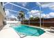 Exterior view of a screened-in swimming pool and patio deck at 1021 Jaybee Ave, Davenport, FL 33897