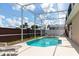 Backyard features a screened in pool and deck area with outdoor seating at 1021 Jaybee Ave, Davenport, FL 33897