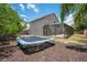 Backyard features trampoline and screened patio, perfect for outdoor fun and relaxation at 1061 Providence Ln, Oviedo, FL 32765