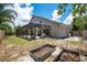 View of backyard with garden beds and a screened-in patio, providing a relaxing outdoor space at 1061 Providence Ln, Oviedo, FL 32765