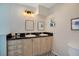 Bathroom featuring dual sinks, tile backsplash, and neutral colored cabinets at 1061 Providence Ln, Oviedo, FL 32765