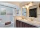 Bright bathroom featuring dual sinks, gold hardware, and decorative tile at 1061 Providence Ln, Oviedo, FL 32765