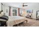 Bright bedroom with a ceiling fan, a large bed, and access to backyard at 1061 Providence Ln, Oviedo, FL 32765