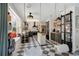 Modern kitchen with black-and-white checkered flooring, stainless steel appliances, and a cozy seating area at 1061 Providence Ln, Oviedo, FL 32765