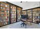 Bright library with hardwood floors, custom built-in bookshelves, and an adjustable height desk perfect for reading and working at 1061 Providence Ln, Oviedo, FL 32765